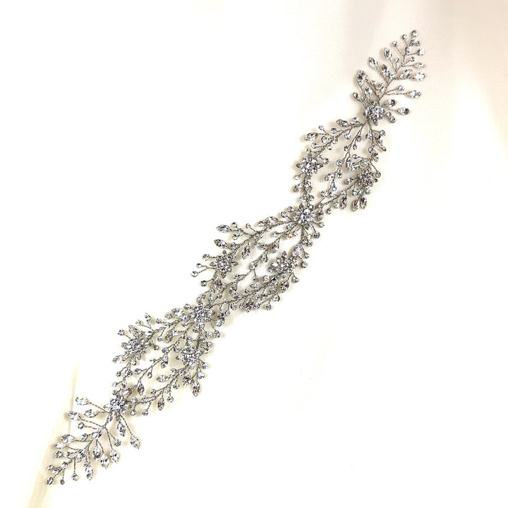 The Delicate Weaving Crystal Hair Vine (style no. 242465) is a Swarovski crystal wedding hair accessory with intricate leaf and branch patterns in an elegant, flowing design. 