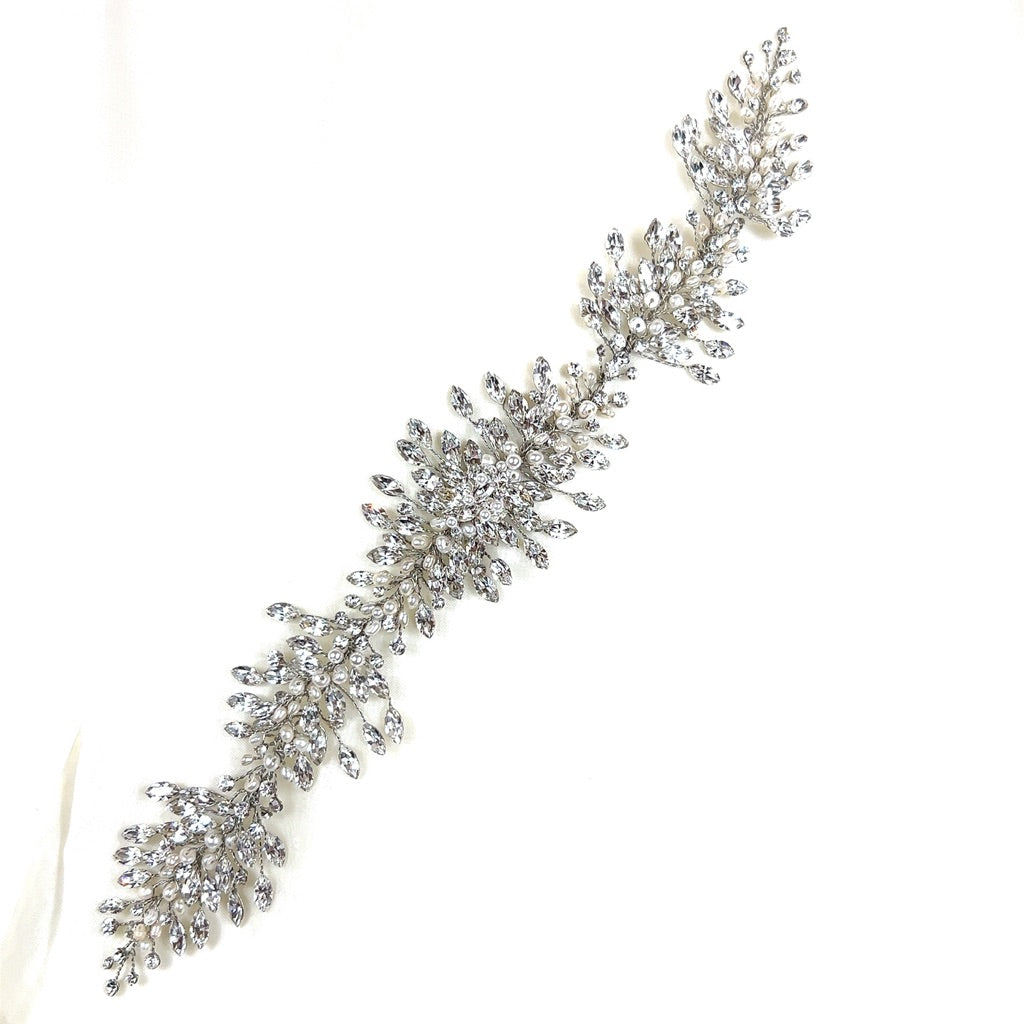 The Elegant Crystal Cluster Hair Vine, style no. 242517, is a Swarovski crystal bridal headpiece with a  leafy branch-shape covered in crystal. It is displayed against a plain white background.