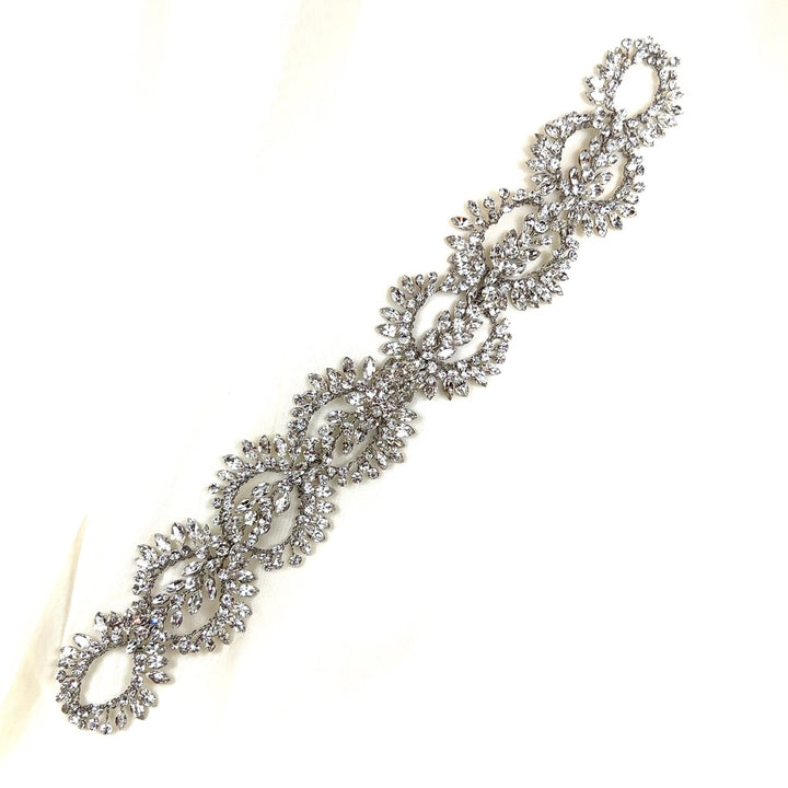 The Crystal Wreath Hair Vine style no. 242643 is a shimmering Swarovski crystal bridal accessory featuring an intricate pattern of interlocking loops and sparkling clear crystals. It is displayed on a pristine white background.