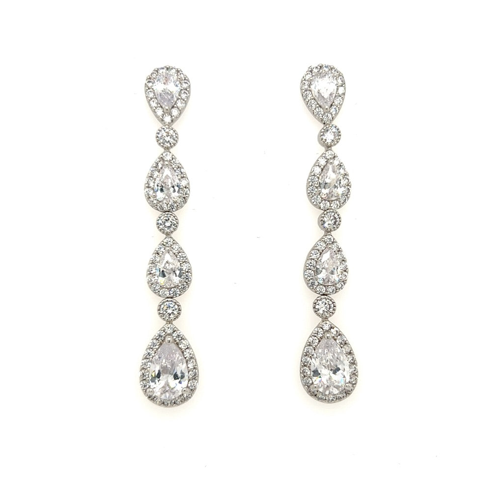 The Shimmering Triple Drop Bridal Earrings feature multiple oval and teardrop-shaped clear CZ stones encircled by smaller stones, creating a sparkling effect on a white background.