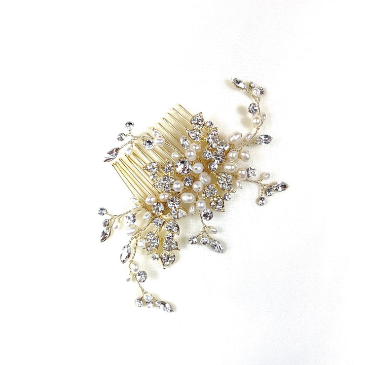 The Delicate Pearl and Crystal Hair Comb (style no. 242691) features an ornate floral and leafy design with pearls and sparkling crystals.