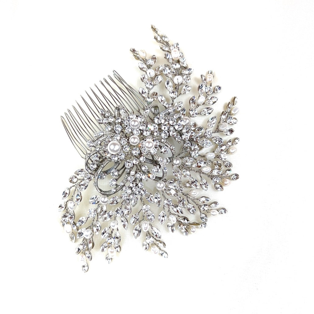 The Swirling Pearl and Crystal Comb, style no. 242580, features intricate floral details encrusted with Swarovski crystals and pearls.