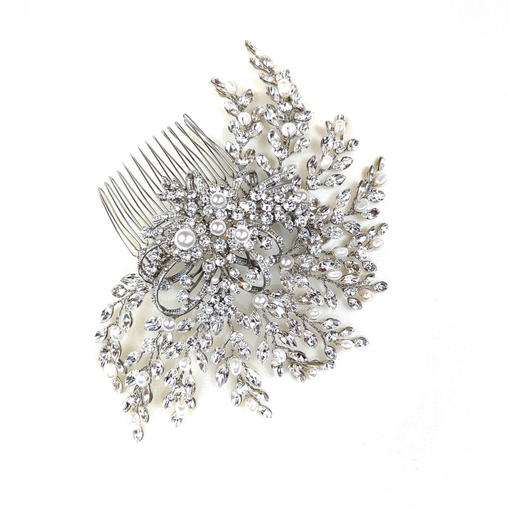 bridal hair comb with round silver detailing surrounded by sweeping branches of crystals and pearls