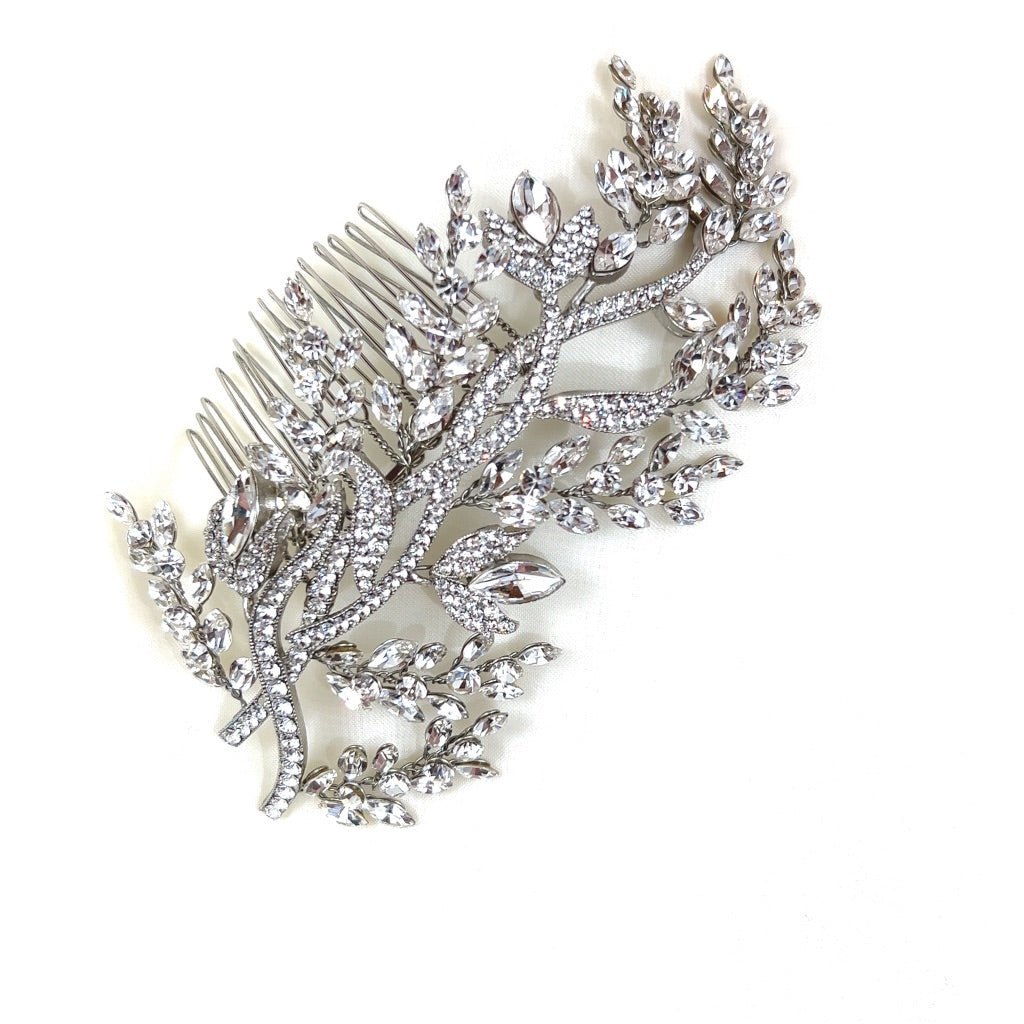 The Enchanted Forest Comb style no. 242462, a Swarovski crystal hair accessory featuring intricate leaf and branch designs, and displayed on a plain white background.