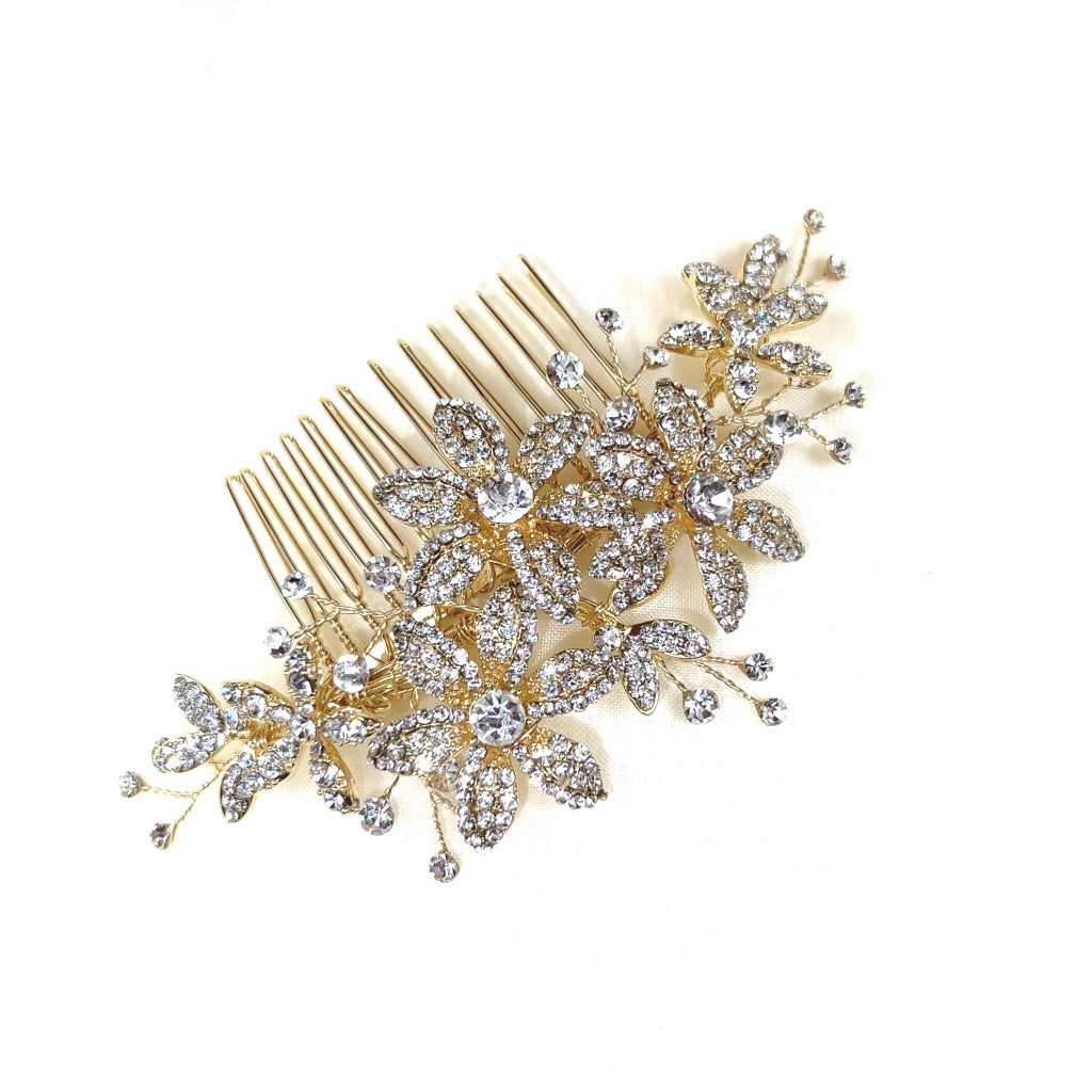 The Delicate Floral Comb (style no. 242692) is a gold and Swarovski crystal bridal hair comb. It features delicate branches and flowers. It is displayed against a plain white background.