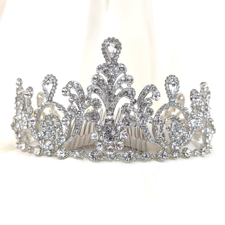 The Classic Swarovski Crystal Crown (style no. 80005) is a sparkling tiara adorned with intricate designs and numerous small glittering crystals, featuring elegant symmetrical motifs and a central floral-like pattern against a plain white background.
