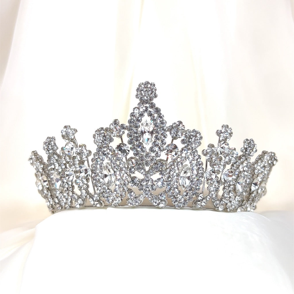 The Royal Wedding Tiara, style no. 80034, is a sparkling Swarovski crystal bridal headpiece  intricately designed with small and large crystals set against a soft white background