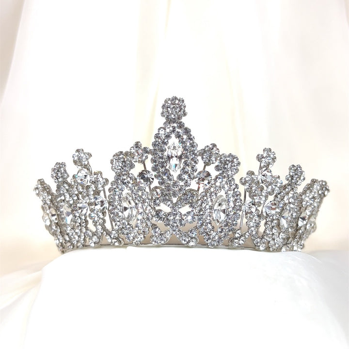 The Royal Wedding Tiara, style no. 80034, is a sparkling Swarovski crystal bridal headpiece  intricately designed with small and large crystals set against a soft white background