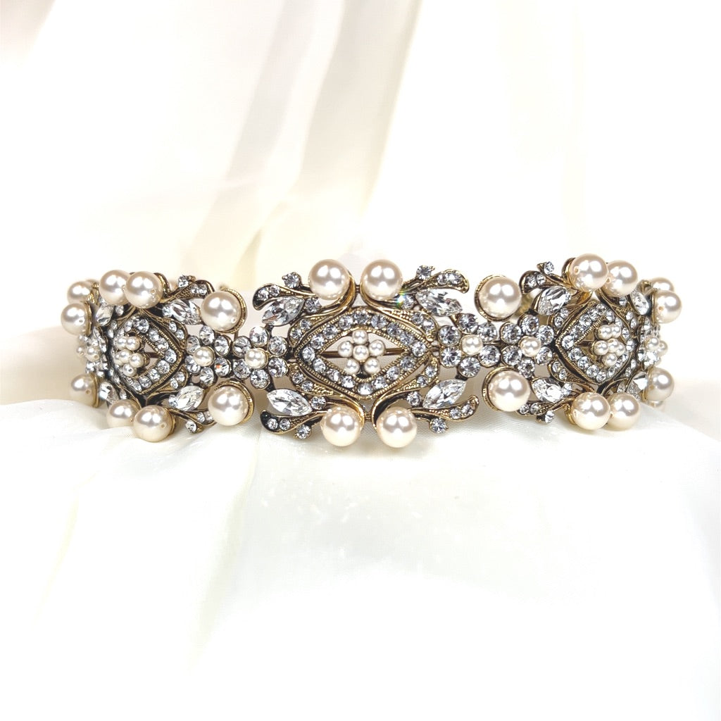 bridal headband with antique gold swirling and floral  detailing surrounding round crystals and large pearls