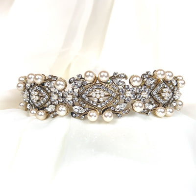 bridal headband with antique gold swirling and floral  detailing surrounding round crystals and large pearls