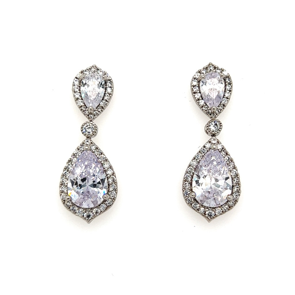 The Glam CZ Double Drop Bridal Earrings (style no. E199) feature teardrop-shaped cubic zirconia framed by sparkling stones, with a matching smaller drop above—perfect for adding elegance to your bridal look.
