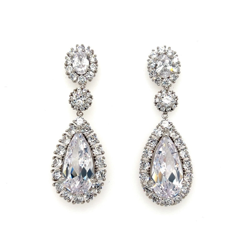 The Elegant CZ Drop Bridal Earrings (style no. E185) feature large teardrop-shaped cubic zirconia surrounded by smaller stones, plus round accents above, all set in silver-tone metal—ideal for weddings or bridal jewelry.
