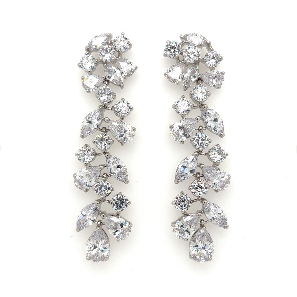The Sophisticated Long Dangle Bridal Earrings (style no. E140) feature clusters of teardrop, round, and marquise-cut cubic zirconia set in silver-tone metal in a cascading design.