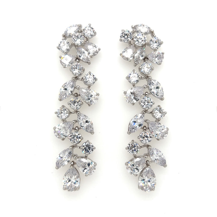 The Sophisticated Long Dangle Bridal Earrings (style no. E140) feature clusters of teardrop, round, and marquise-cut cubic zirconia set in silver-tone metal in a cascading design.