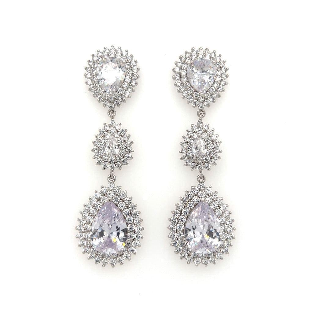 The Double Drop CZ Bridal Earrings (style no. E142) feature three vertical, teardrop-shaped CZ gems surrounded by smaller stones. They pair effortlessly with our Swarovski bridal tiara for a stunning, cohesive look.