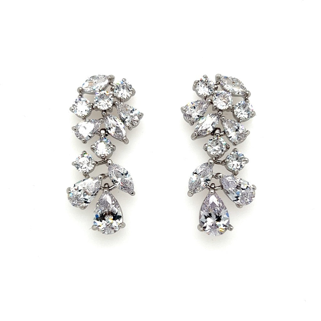 The Floral Vine CZ Dangle Bridal Earrings (style no. E207) feature multiple sparkling cubic zirconia stones in teardrop, marquise, and round cuts, arranged in an elegant cascading floral vine design.
