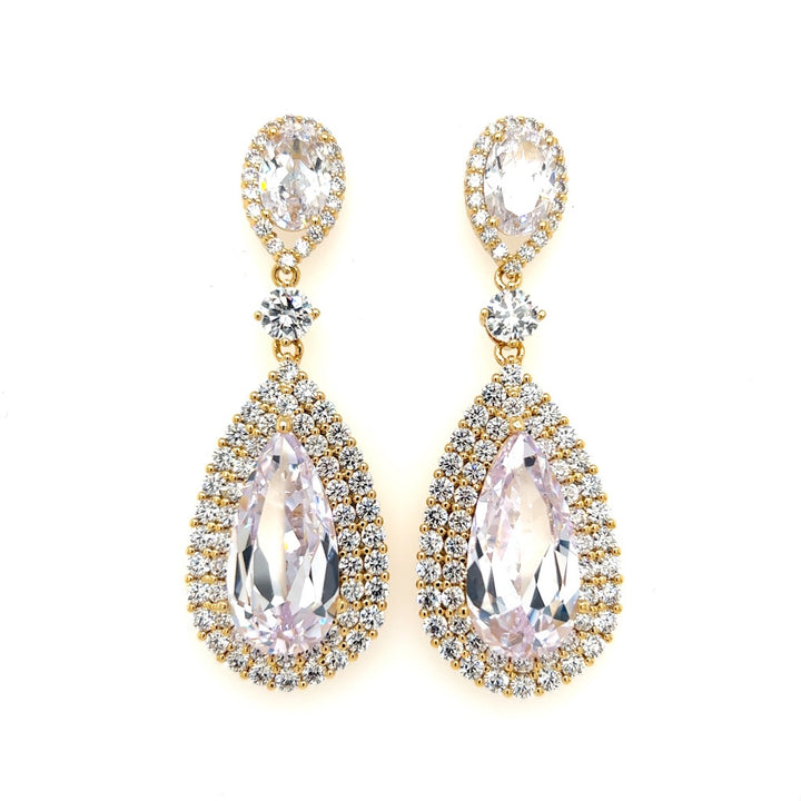The Pear-shaped CZ Wedding Earrings (style no. E147) are elegant gold drop earrings with teardrop-shaped cubic zirconia, smaller stones surrounding them, an oval gemstone at the post, and a round accent in between; perfect for pairing with a Swarovski crystal crown.
