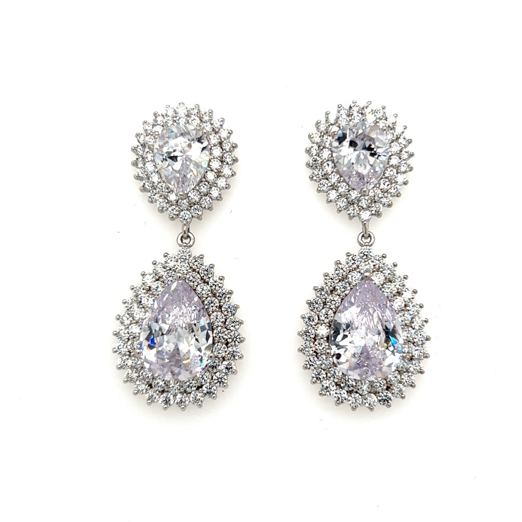 The Glam Short Dangle Earrings (style no. E190) feature silver double teardrop drops with clear cubic zirconia centers, each encircled by two rows of sparkling stones—perfect for bridal elegance or any special occasion.