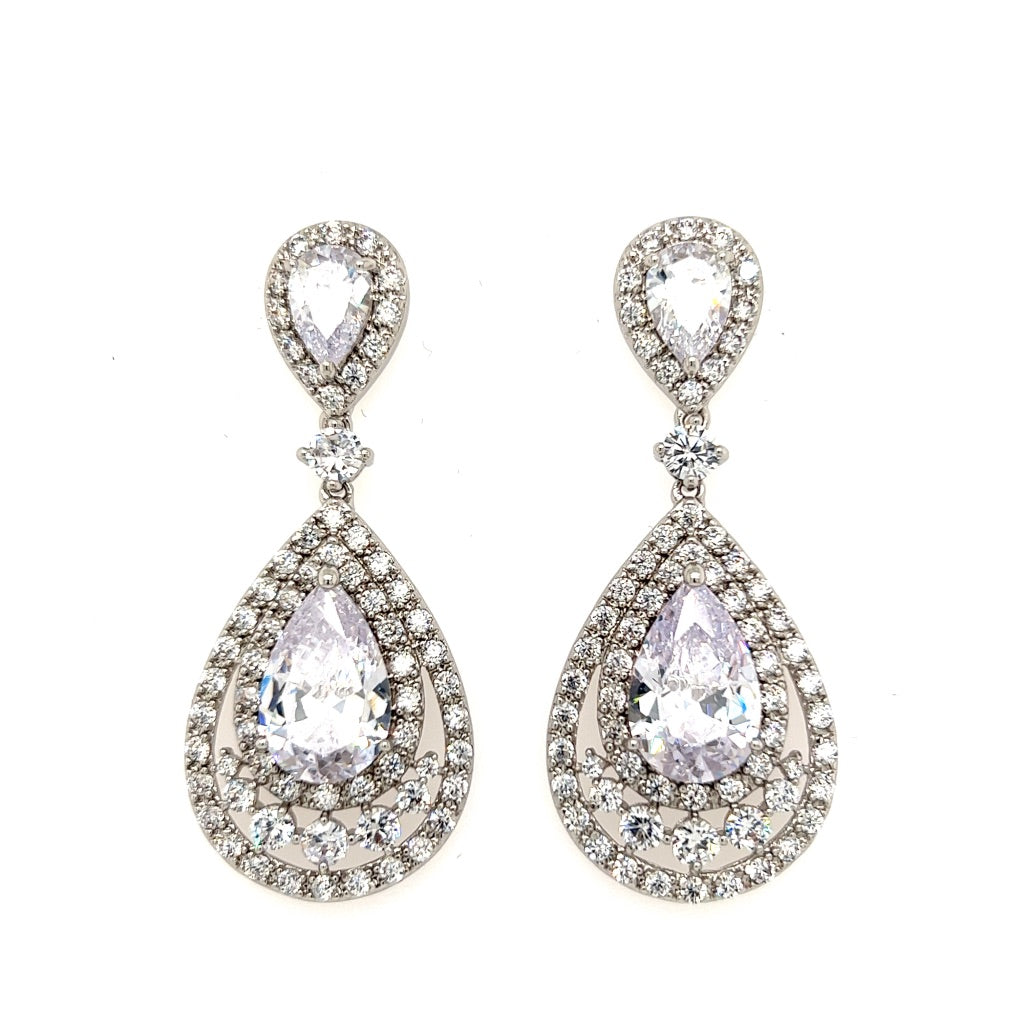 The Shimmering Dangle Drop Earrings (style no. E141) feature teardrop-shaped clear cubic zirconia and rows of round white stones elegantly set in silver metal—perfect as a luxury bridal accessory.