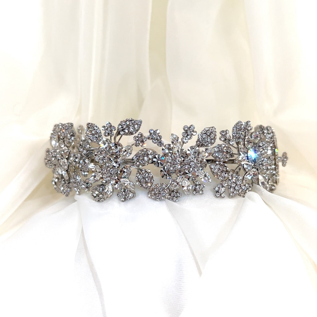 silver bridal headband with various crystal flowers and small clusters