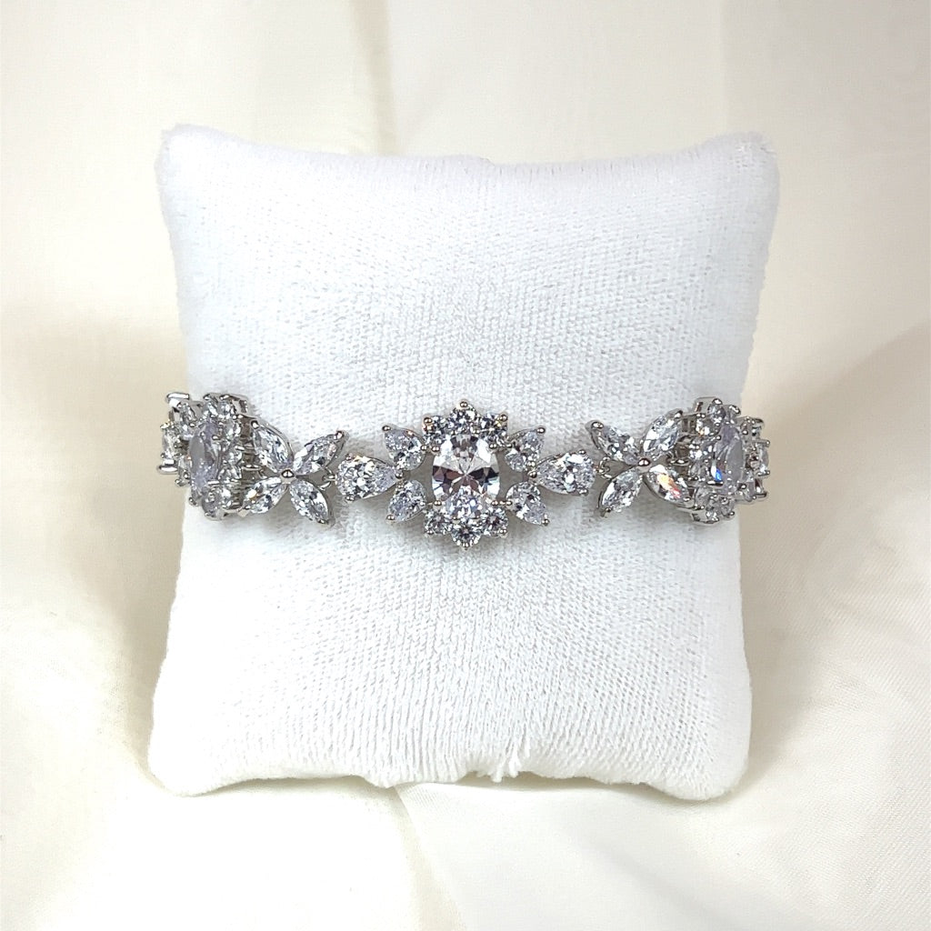 The Romantic Floral Bridal Bracelet (style no. B151), with its elegant silver and sparkling floral and leaf designs set with clear cubic zirconia gemstones, perfectly complements a Swarovski crystal tiaras.
