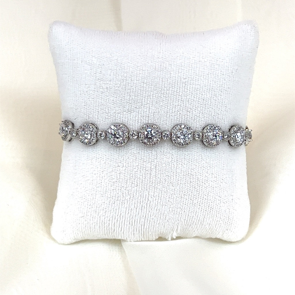 The Classic Sophisticated CZ Bracelet (style no. B141), elegantly showcased on a white cushioned stand, features circular settings with sparkling Cubic Zirconia stones, echoing the refinement typical of Swarovski crystal wedding headpieces.