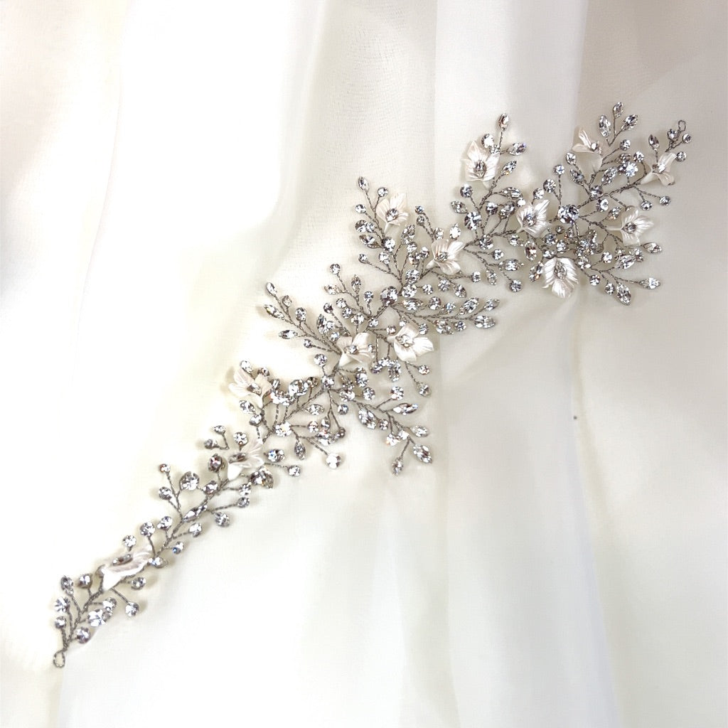 asymmetrical bridal hair vine with branchy sprigs of crystal and porcelain flower details