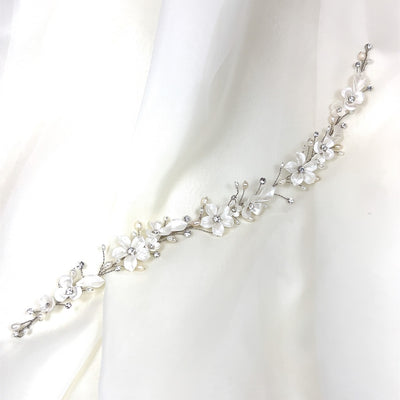 thin bridal hair vine with crystals, pearls, and porcelain flowers