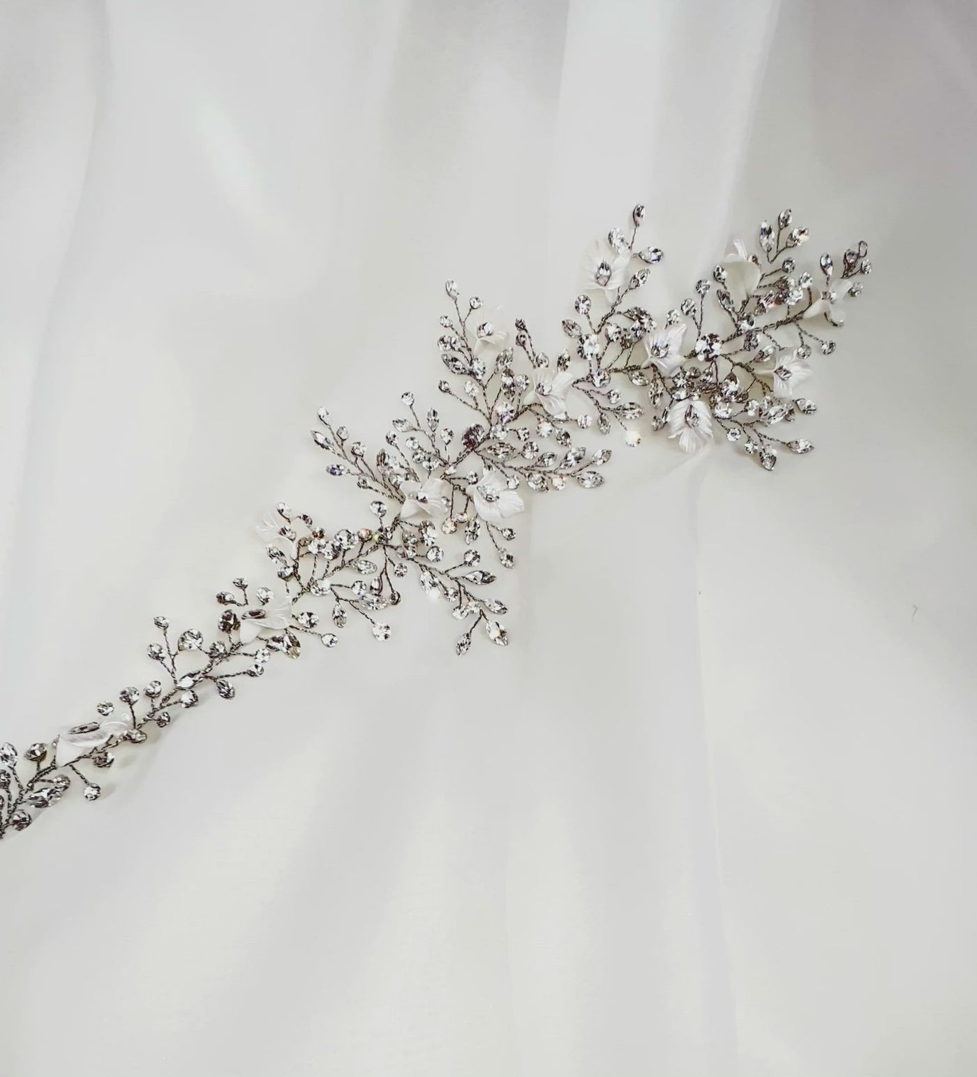 asymmetrical bridal hair vine with branchy sprigs of crystals and porcelain flowers