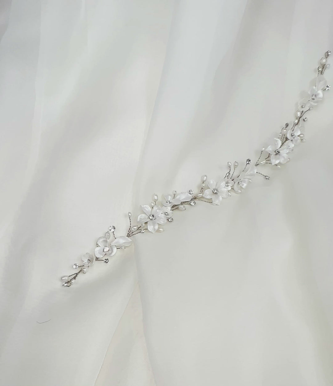 thin bridal hair vine with crystals, pearls, and porcelain flowers