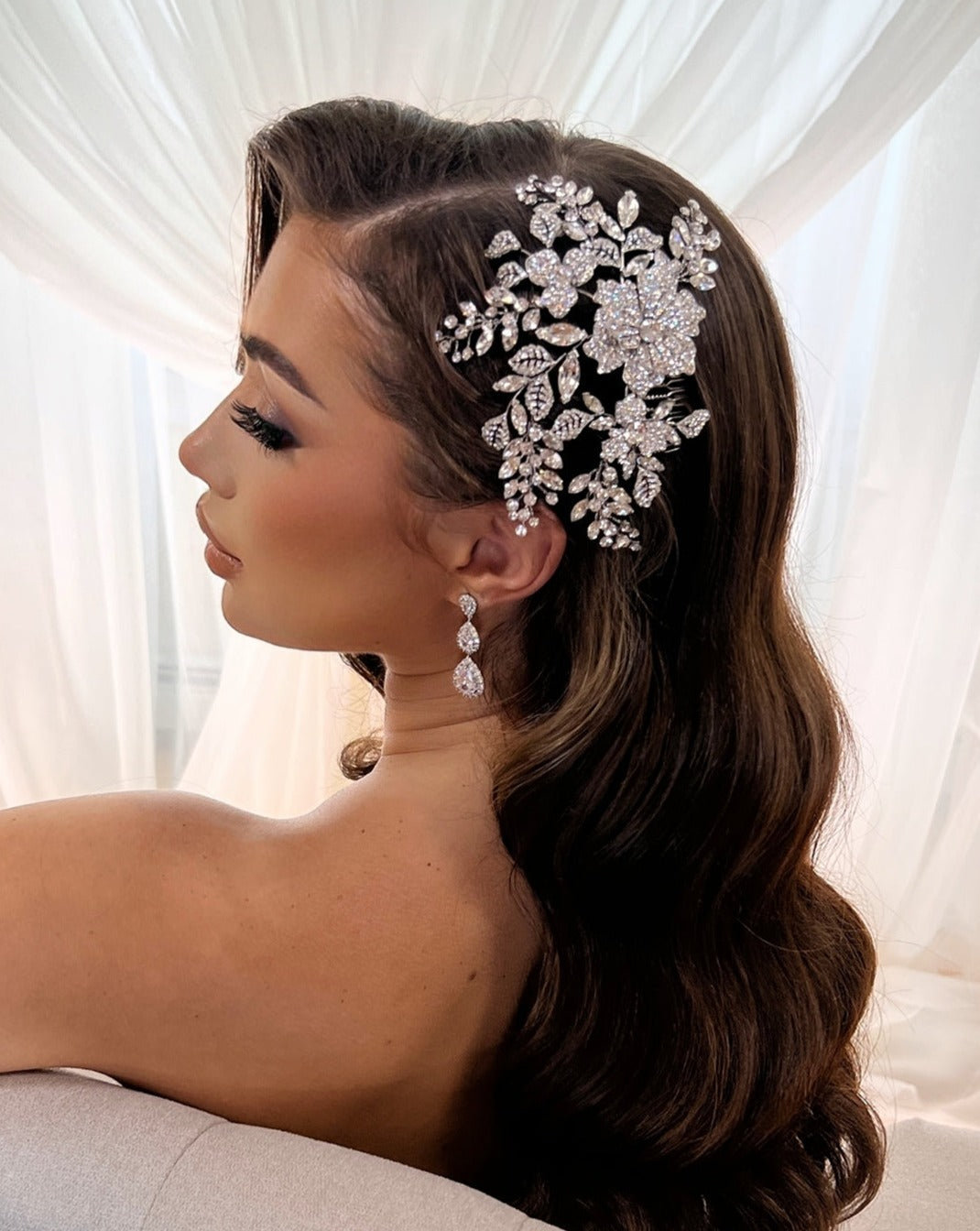female model wearing bridal hair comb with floral and leafy crystal details