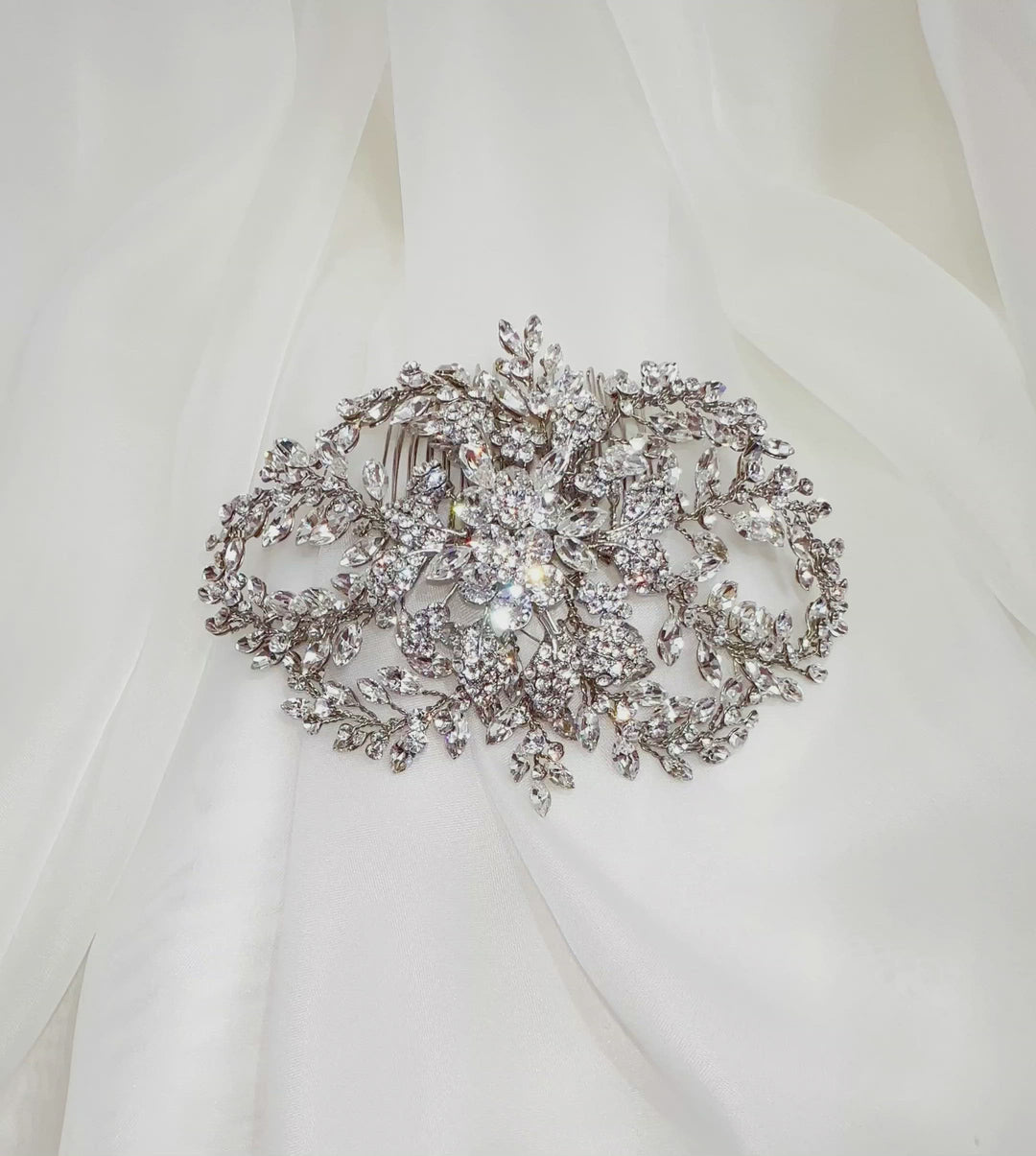 silver bridal hair comb with flower detailing and rounded sprays of crystals