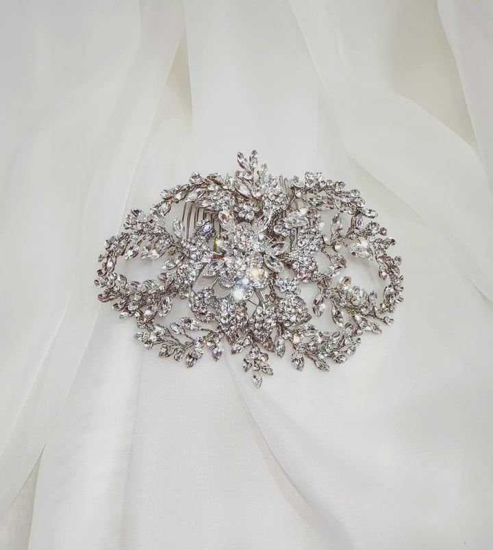 silver bridal hair comb with flower detailing and rounded sprays of crystals