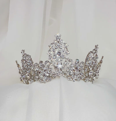 silver bridal crown with various rounded crystal peaks and sparkling floral details