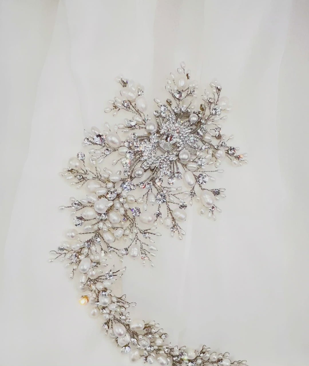 asymmetrical silver bridal hair vine with various crystals and pearls