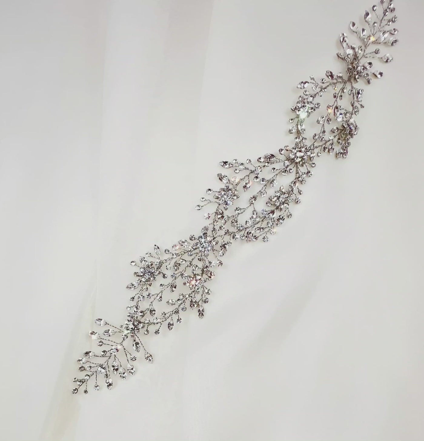 thin silver looping bridal hair vine with sparkling crystal sprigs and flower details