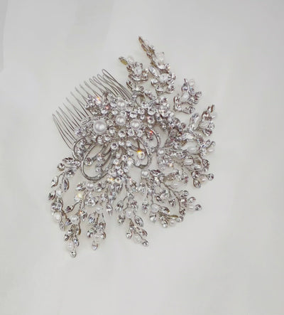 bridal hair comb with round silver detailing surrounded by sweeping branches of sparkling crystals and pearls