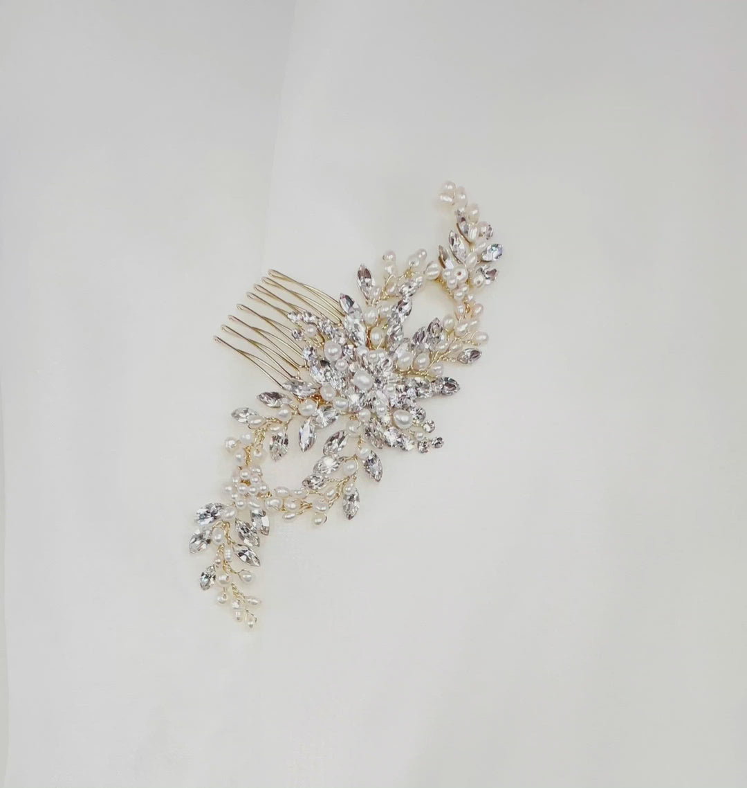 gold looping bridal hair comb with small sprays of sparkling crystals and pearl detailing