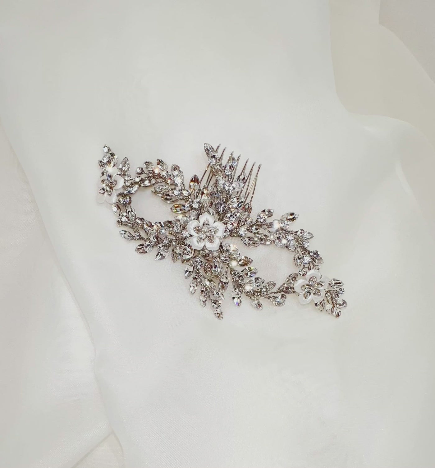 bridal hair comb with swirling double loop crystal sprigs and porcelain flower details